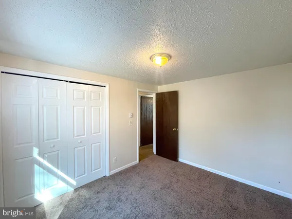 a view of an empty room with a fan