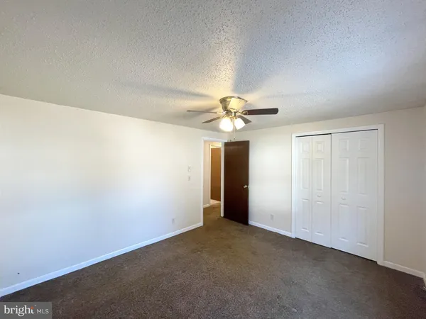 an empty room with closet area