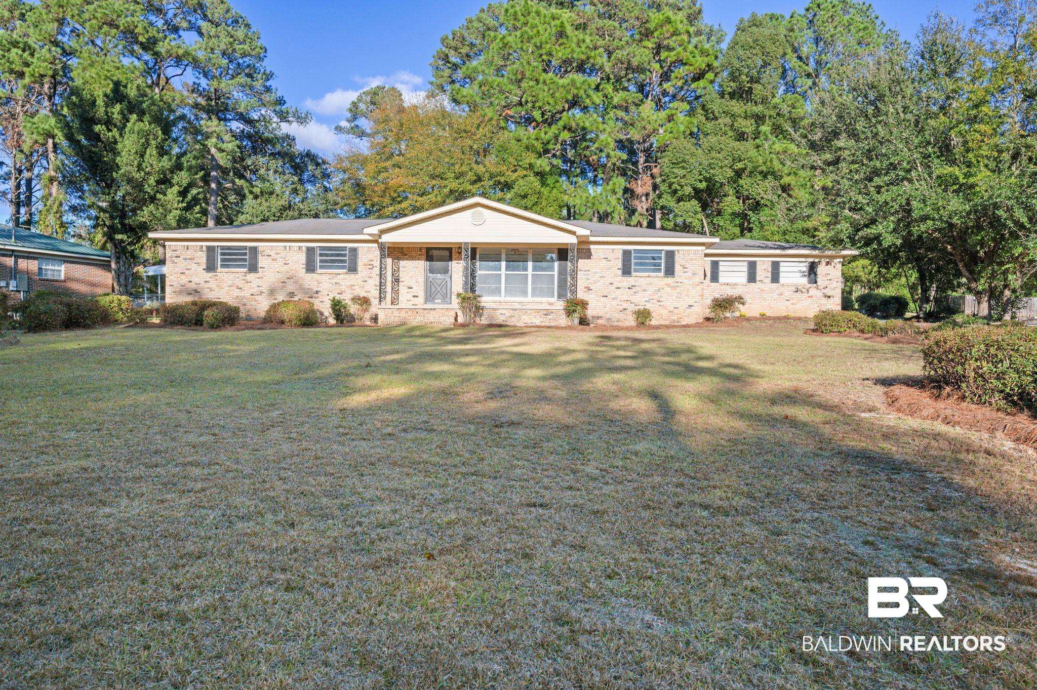 909 Caroline Avenue Daphne, AL 36526 - Photo 1 of 46 Ranch-style home featuring a front yard and a porch