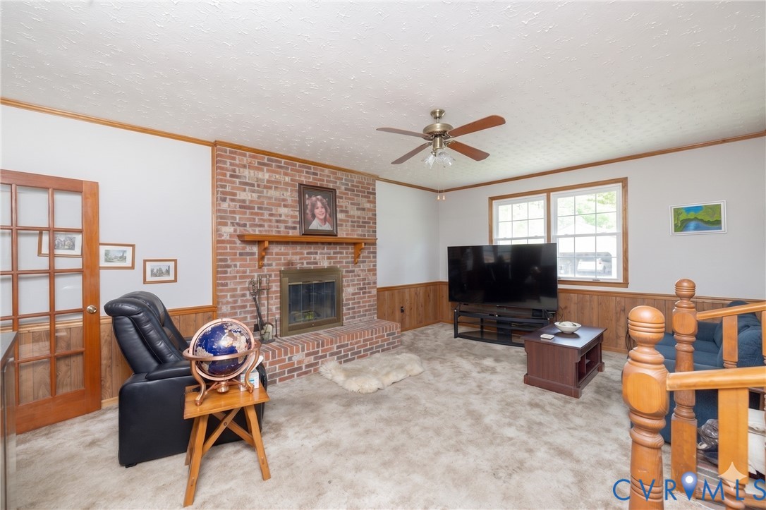 712 Keswick Road Colonial Heights, VA 23834 - Photo 15 of 34 a living room with furniture a flat screen tv and a fireplace