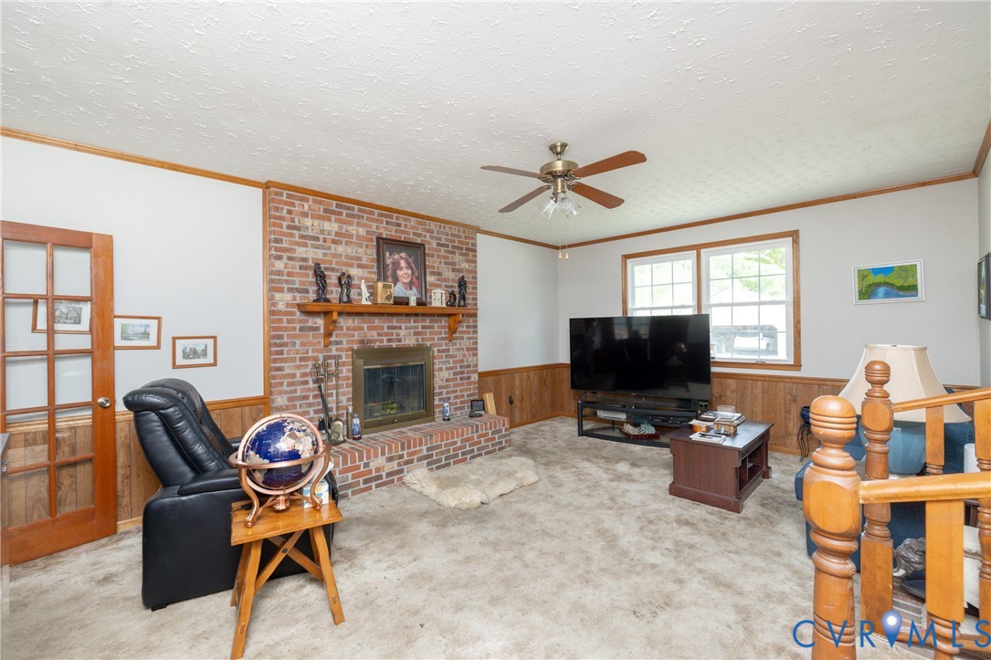 712 Keswick Road Colonial Heights, VA 23834 - Photo 17 of 34 a living room with furniture a fireplace and a flat screen tv