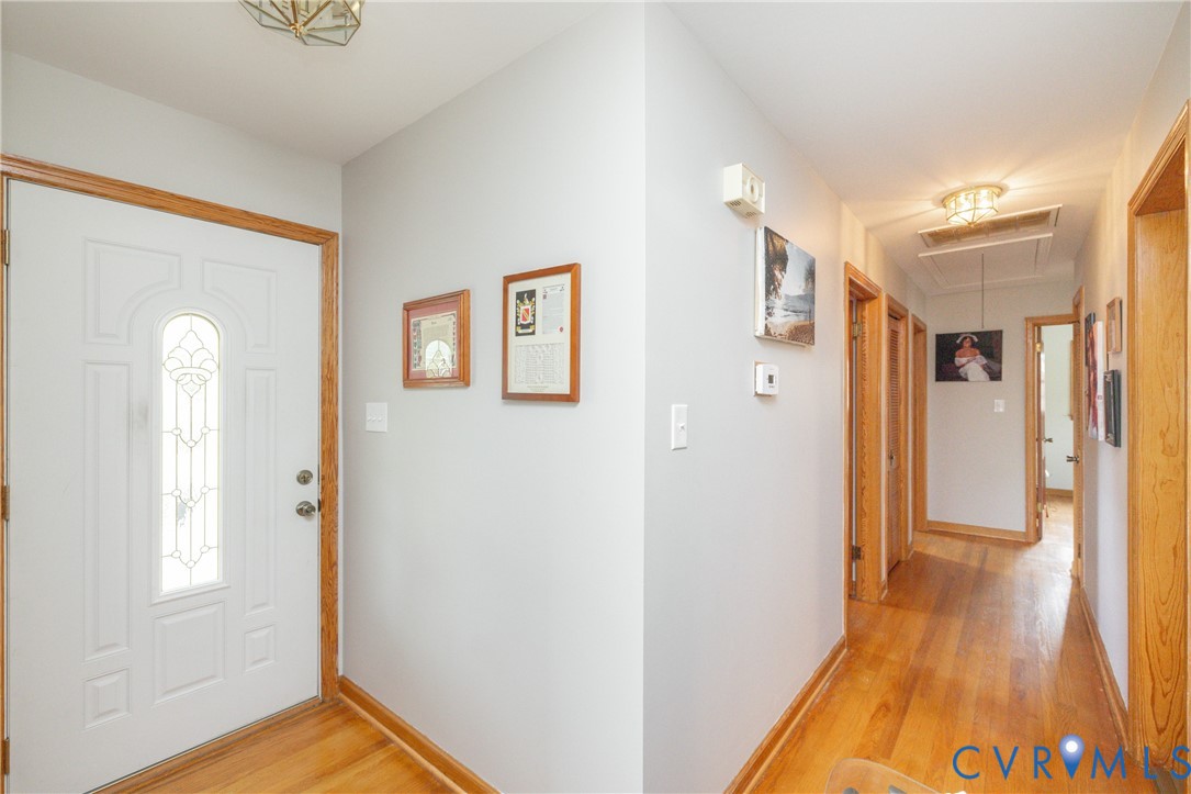 712 Keswick Road Colonial Heights, VA 23834 - Photo 6 of 34 a view of a hallway with wooden floor and a bathroom