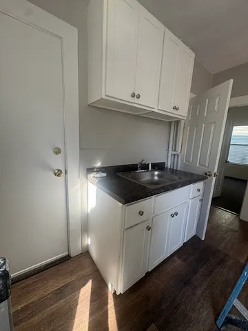 a kitchen with granite countertop cabinets and sink