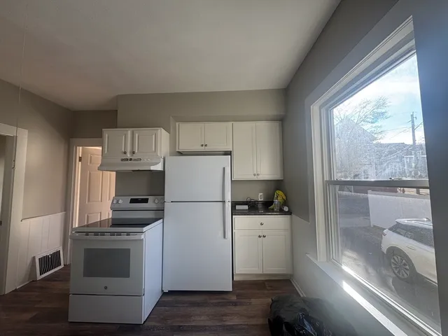 a kitchen with a white cabinets and white appliances