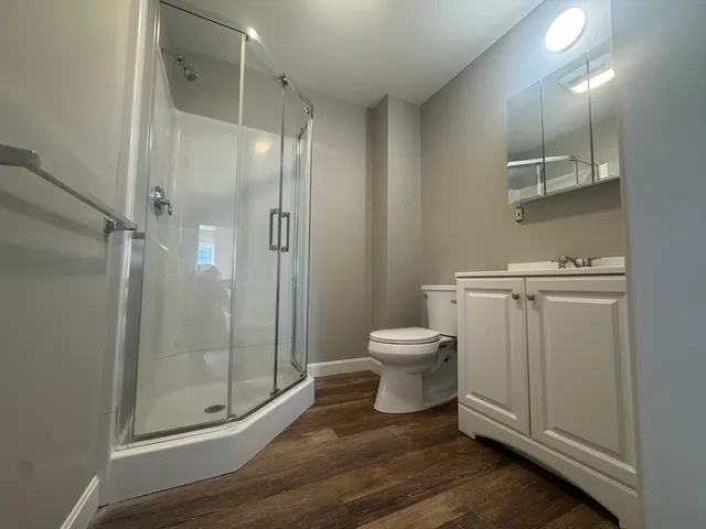 a bathroom with a toilet and a glass door