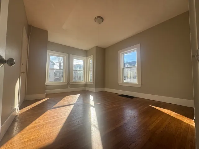 a view of an entryway with wooden floor and a window