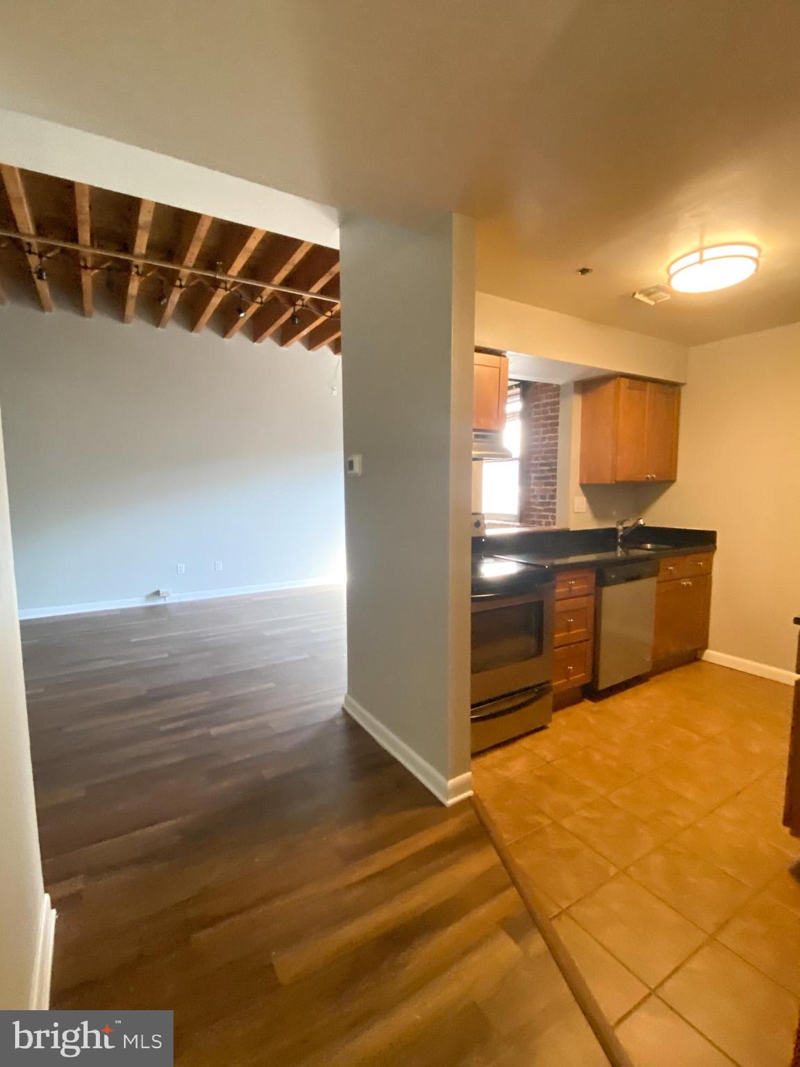 225 Arch Street Philadelphia, PA 19106 - Photo 3 of 13 a view of kitchen and empty room with wooden floor