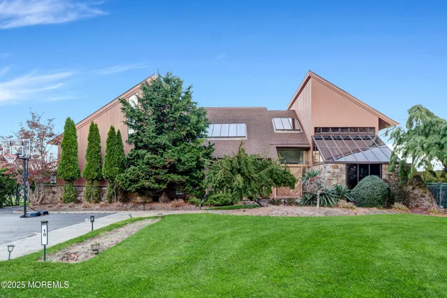 a front view of a house with a garden