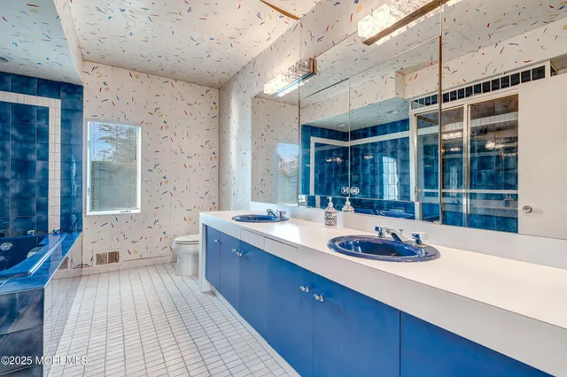 a bathroom with a granite countertop sink mirror and shower
