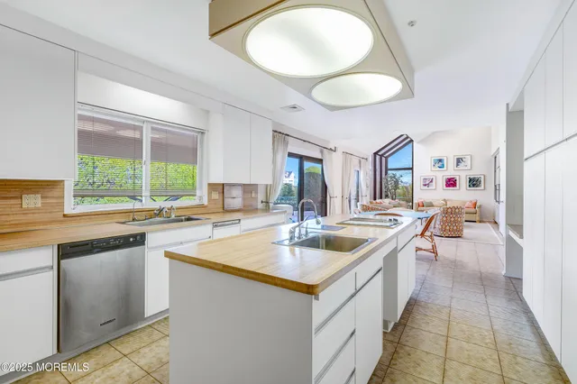 a kitchen with stainless steel appliances granite countertop a sink and a refrigerator