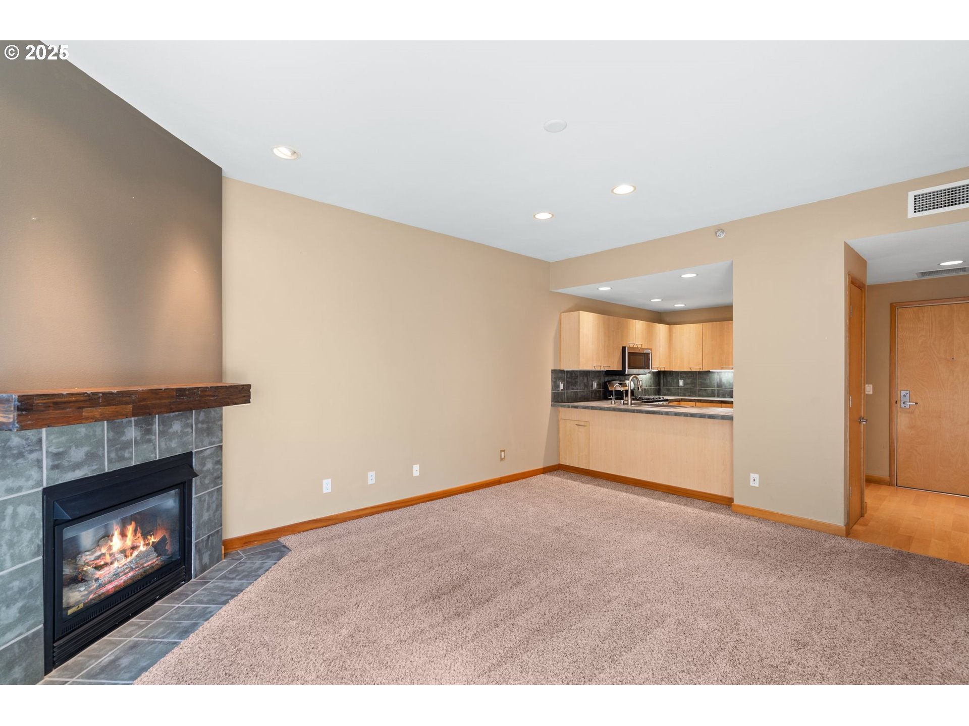400 West 8th Street, Unit 236 Vancouver, WA 98660 - Photo 13 of 35 a view of empty room with kitchen and fireplace
