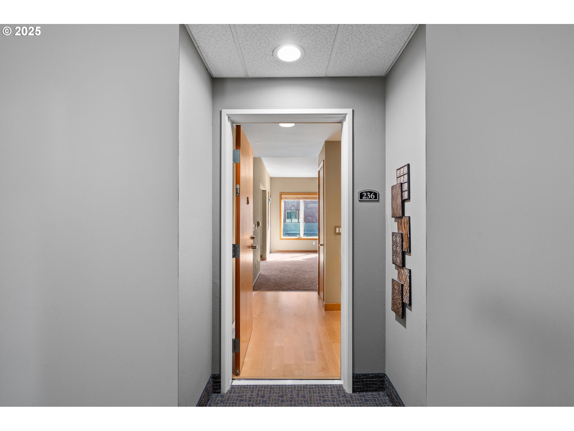 400 West 8th Street, Unit 236 Vancouver, WA 98660 - Photo 7 of 35 a view of a hallway with wooden floor and front door