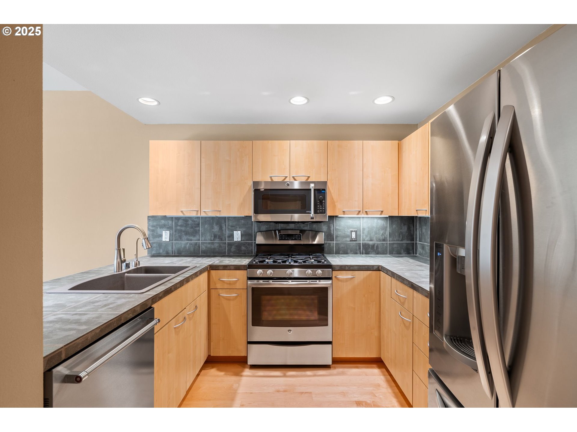 400 West 8th Street, Unit 236 Vancouver, WA 98660 - Photo 9 of 35 a kitchen with stainless steel appliances granite countertop a stove a refrigerator and a sink