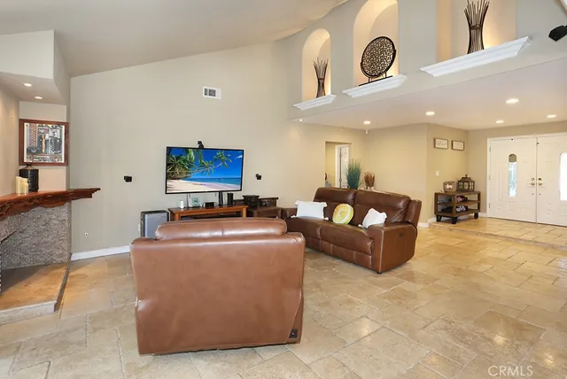 a living room with furniture and a clock