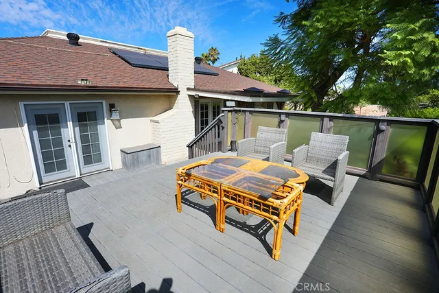 a balcony with furniture and wooden floor