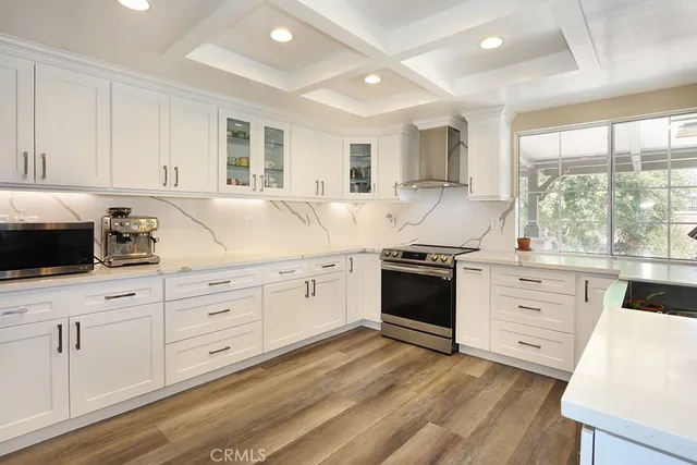 a kitchen with granite countertop white cabinets and white appliances