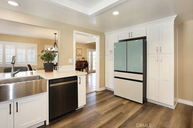 a kitchen with wooden floors and appliances