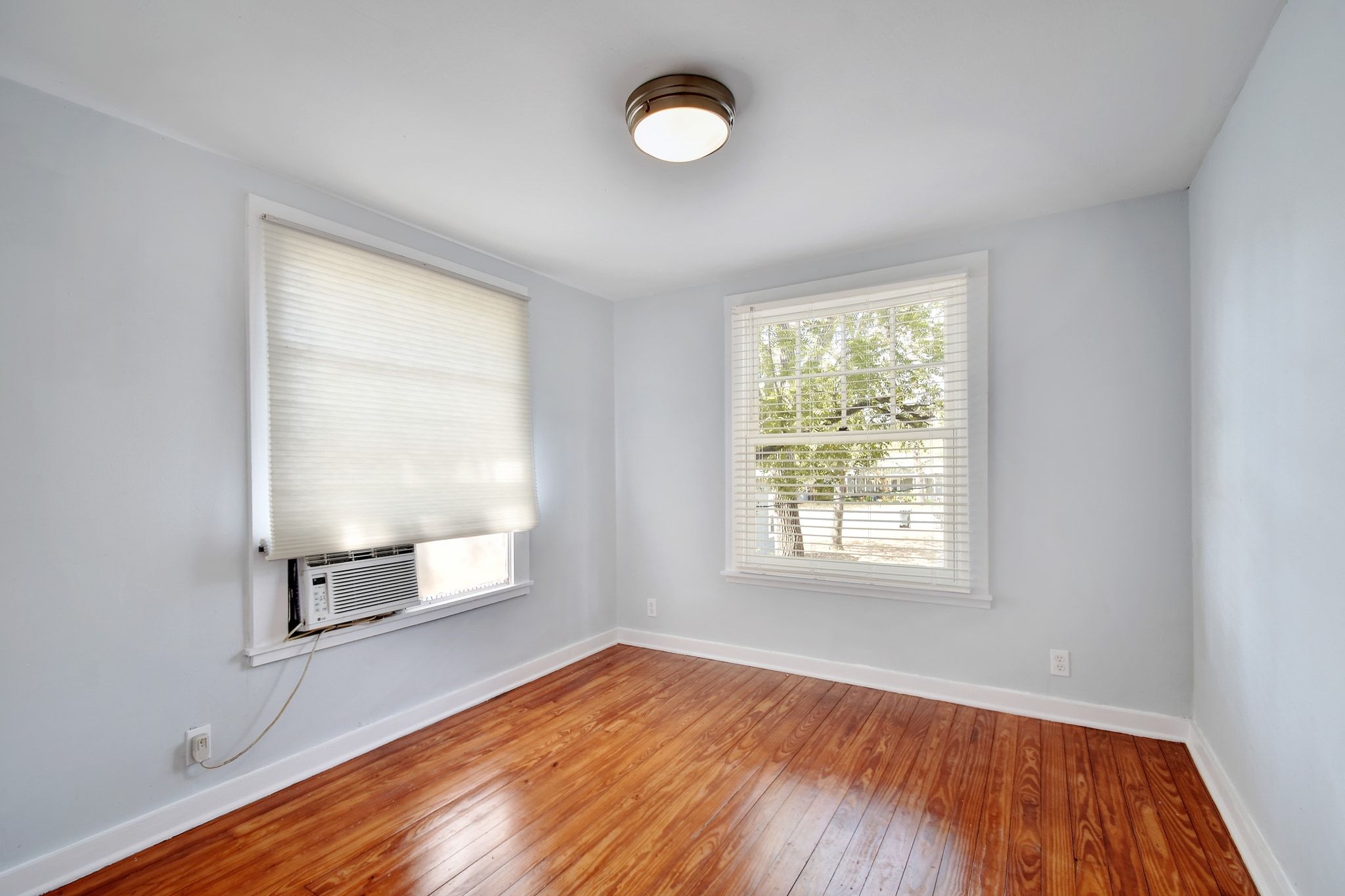 717 South Laurel Avenue Luling, TX 78648 - Photo 29 of 34 an empty room with wooden floor cabinet and windows
