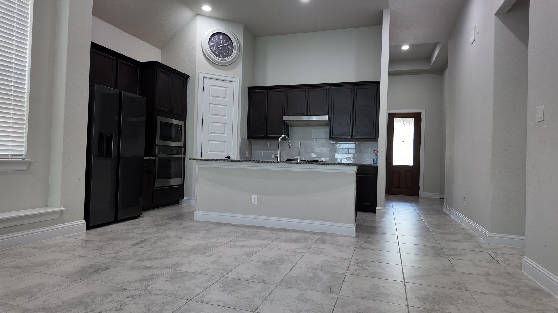 2320 Base Burner Path Leander, TX 78641 - Photo 10 of 24 Culinary creations come to life in this kitchen, complete with a generous island and sleek dark cabinetry.