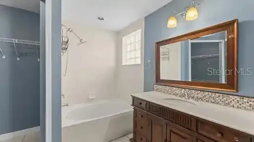 a bathroom with a bathtub and a sink