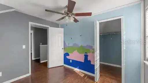 wooden floor in an empty room with a mirror