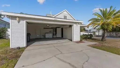 a view of a house with a space and a garage
