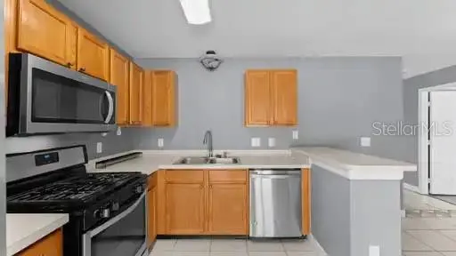 a kitchen that has a sink and a stove in it