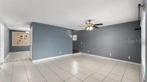 a view of a livingroom with a ceiling fan and window