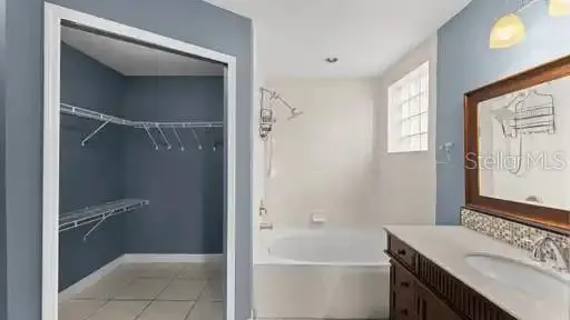 a bathroom with a sink vanity tub and shower