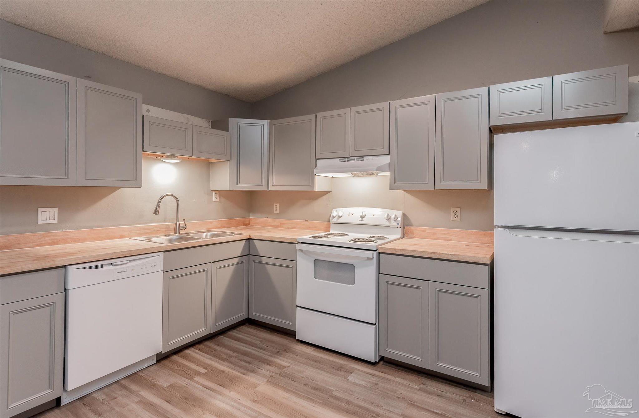 8210 Kipling Street, Unit A Pensacola, FL 32514 - Photo 1 of 13 a kitchen with sink stove and cabinets