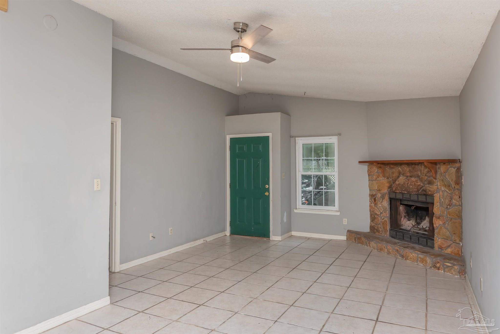 8210 Kipling Street, Unit A Pensacola, FL 32514 - Photo 3 of 13 a view of an empty room with window and fire place