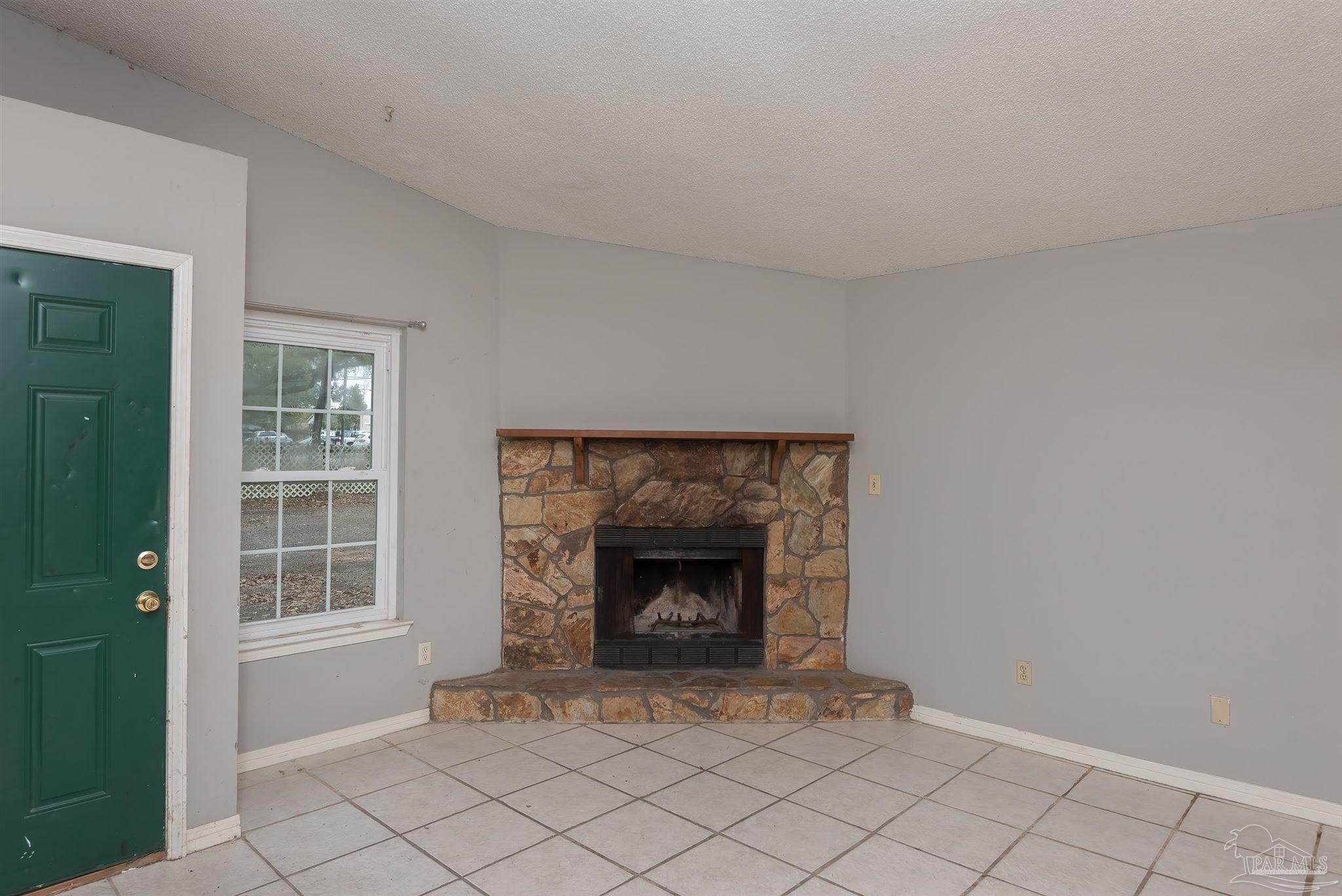 8210 Kipling Street, Unit A Pensacola, FL 32514 - Photo 4 of 13 a living room with a fireplace