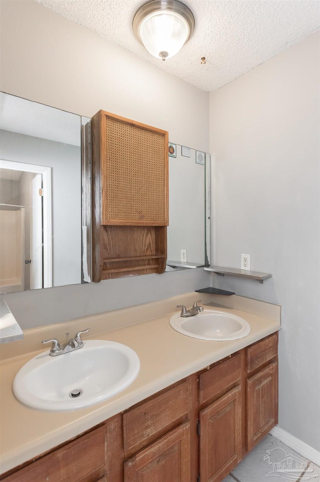 8210 Kipling Street, Unit A Pensacola, FL 32514 - Photo 7 of 13 a bathroom with a sink and a mirror