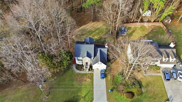 a view of a white house with large windows and a trees
