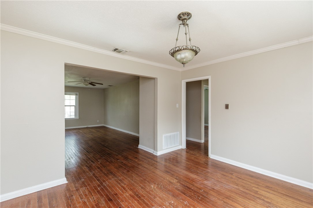 3513 Monterrey Street Corpus Christi, TX 78411 - Photo 11 of 34 a view of an empty room with wooden floor and a window