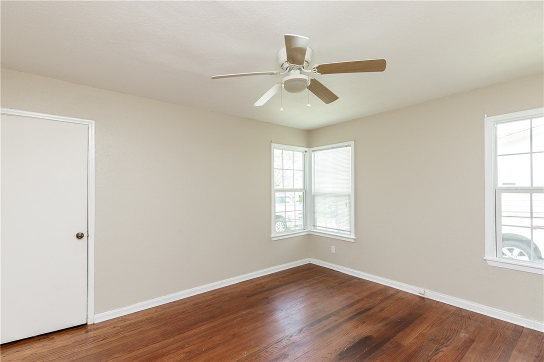 3513 Monterrey Street Corpus Christi, TX 78411 - Photo 13 of 34 a view of an empty room with wooden floor and a window