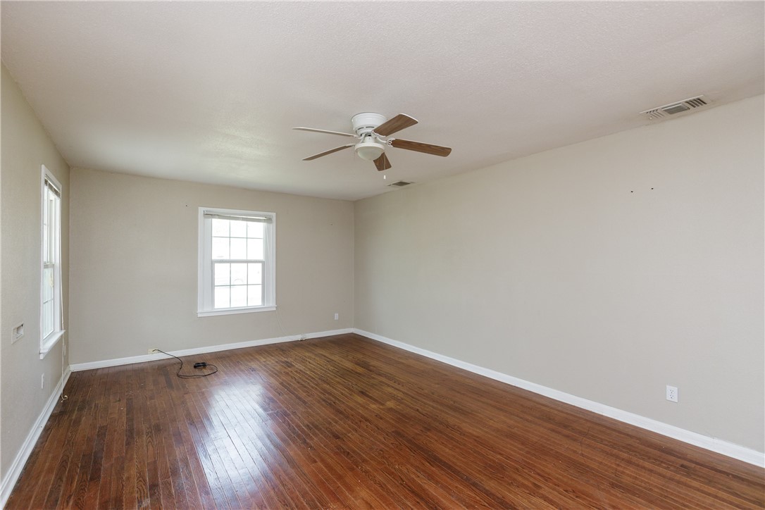 3513 Monterrey Street Corpus Christi, TX 78411 - Photo 18 of 34 wooden floor in an empty room with a window