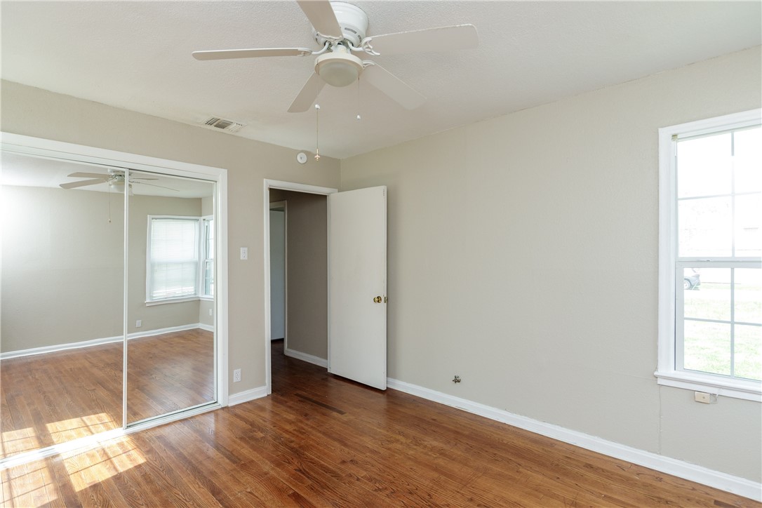 3513 Monterrey Street Corpus Christi, TX 78411 - Photo 21 of 34 wooden floor in an empty room with a window