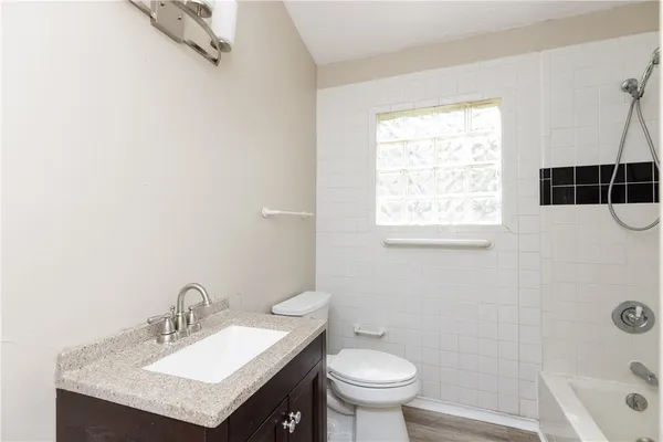 a bathroom with a shower and a window