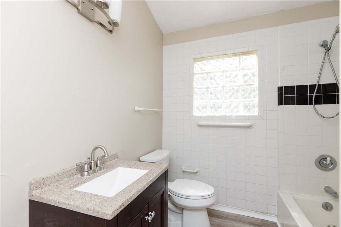 3513 Monterrey Street Corpus Christi, TX 78411 - Photo 22 of 34 a bathroom with a sink toilet a mirror and shower