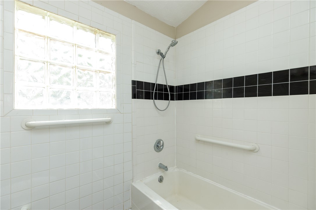 3513 Monterrey Street Corpus Christi, TX 78411 - Photo 23 of 34 a bathroom with a shower and a window