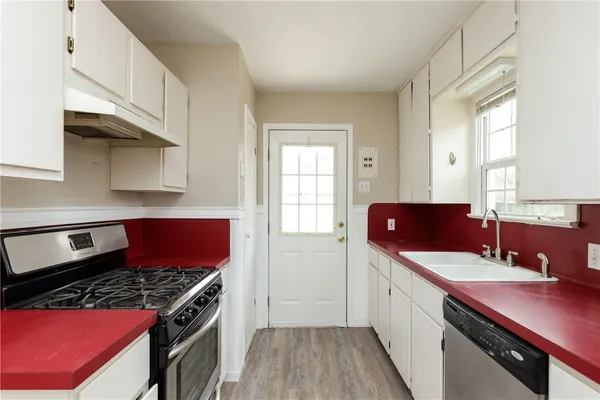 a kitchen with stainless steel appliances a stove a sink and a refrigerator