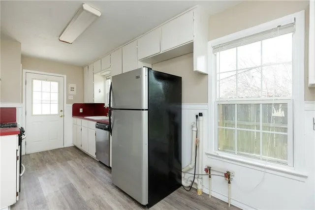 a kitchen with a sink a window and stainless steel appliances
