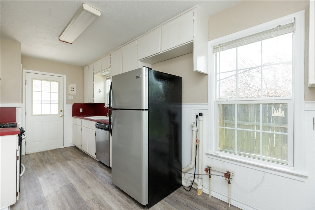 3513 Monterrey Street Corpus Christi, TX 78411 - Photo 28 of 34 a kitchen with a refrigerator and a window