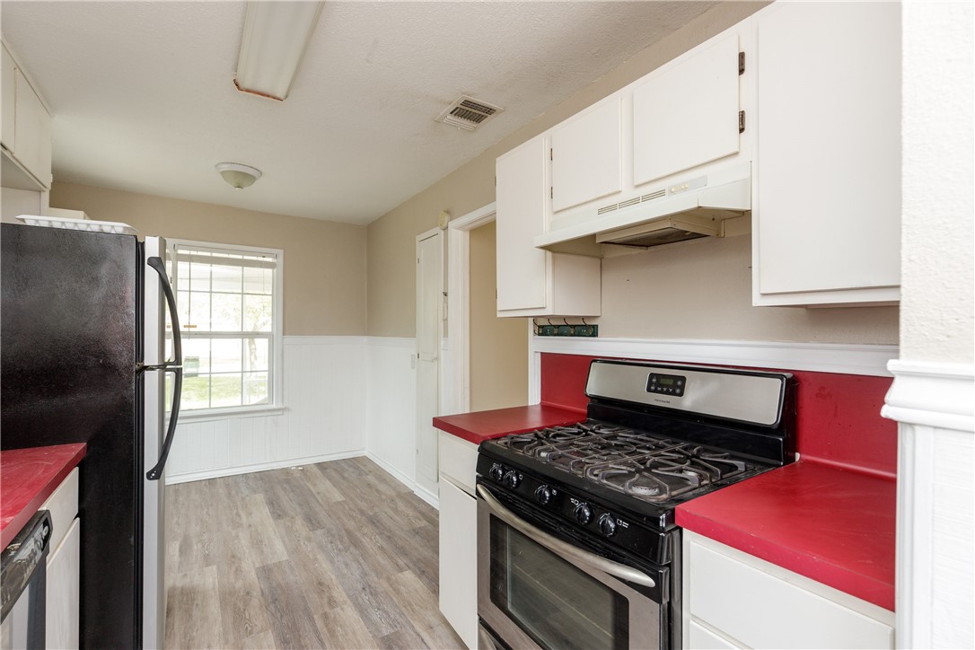 3513 Monterrey Street Corpus Christi, TX 78411 - Photo 30 of 34 a kitchen with stainless steel appliances granite countertop a stove and a refrigerator