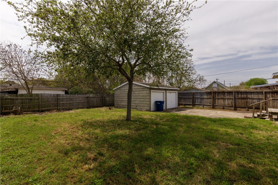 3513 Monterrey Street Corpus Christi, TX 78411 - Photo 32 of 34 a view of a backyard with table and chairs and wooden fence