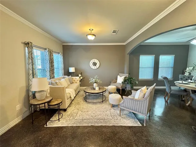 a living room with furniture rug and window