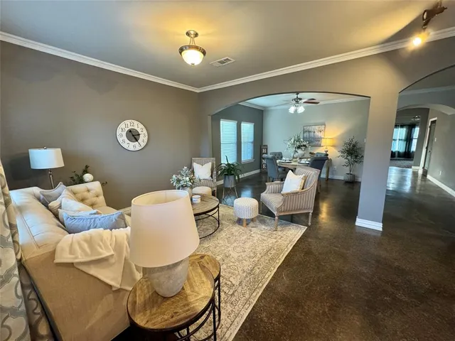 a living room with furniture and a clock