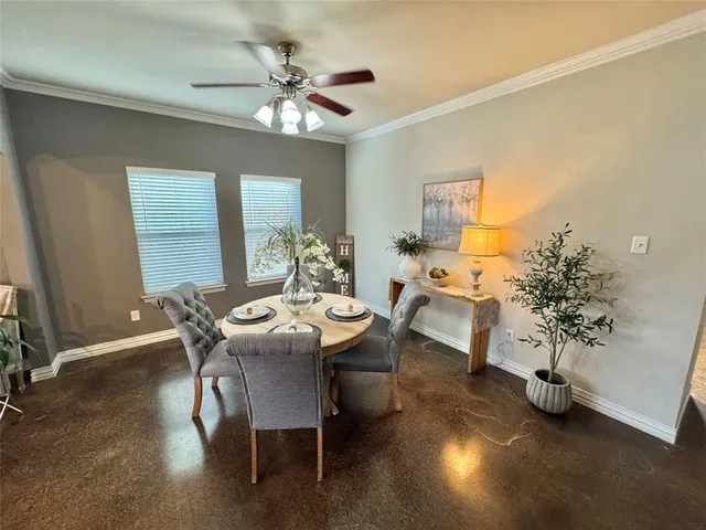a view of a dining room with furniture and chandelier