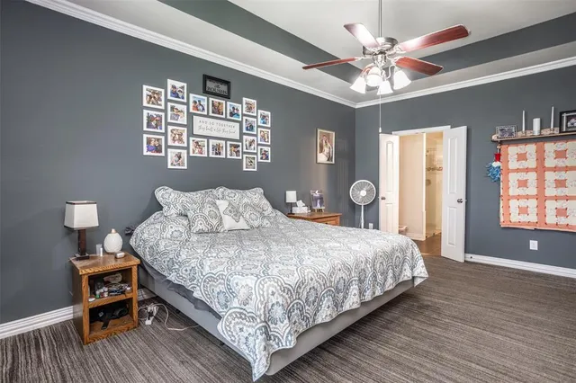 a bedroom with a bed chandelier and a window